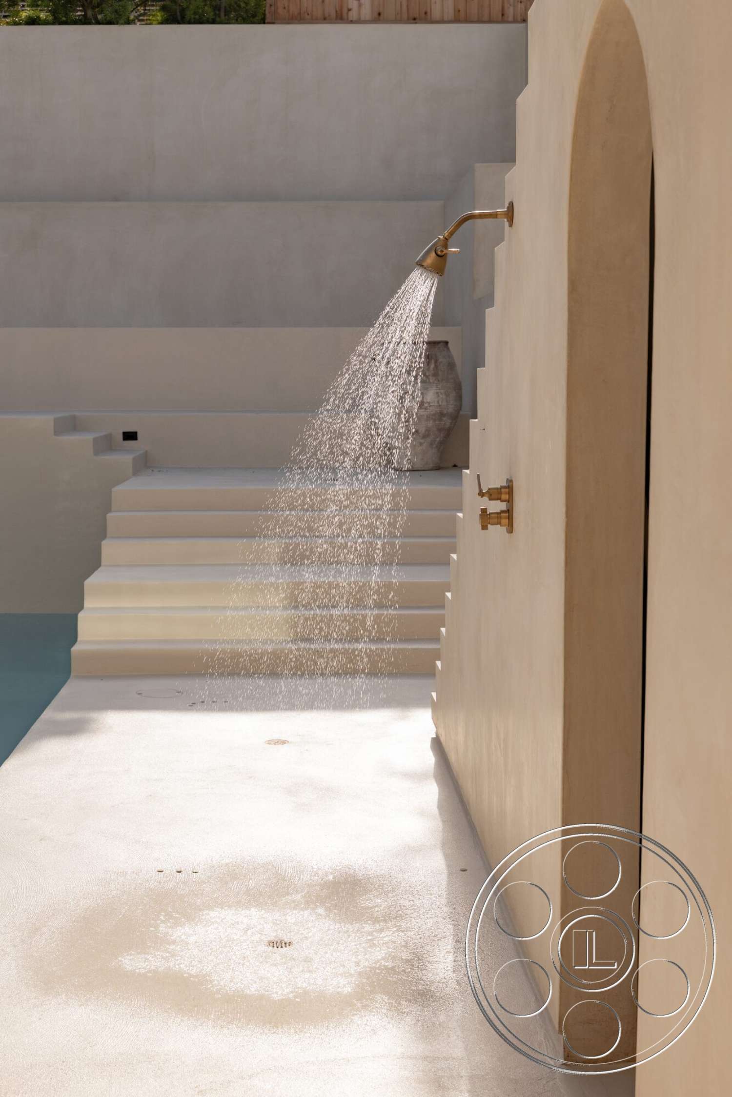Modern 535 - exterior, water feature, concrete steps, textured concrete flooring, outdoor shower area, minimalist architectural design, sunlit patio space, plastered wall finish, golden brass shower fixture