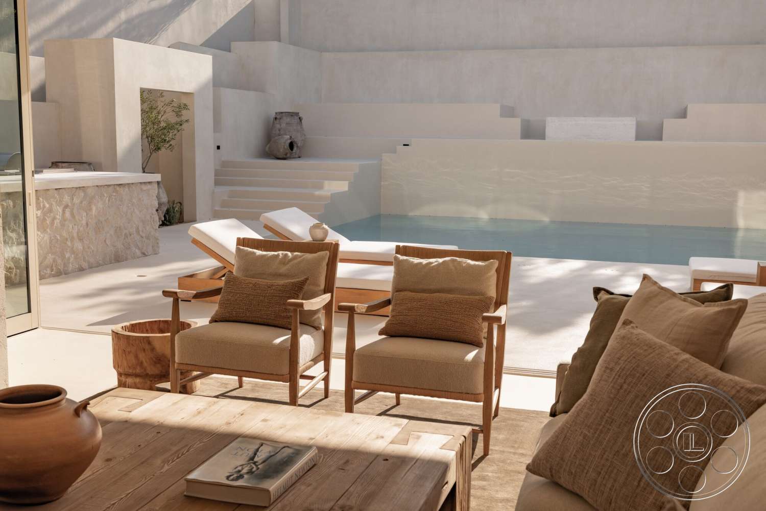 Modern 535 - natural light, wood coffee table, minimalist aesthetic, concrete flooring, open concept layout, large glass doors, concrete walls, textured throw pillows, sunlit pool area, rectangular pool, wooden lounge chairs, stone feature wall, terracotta pottery