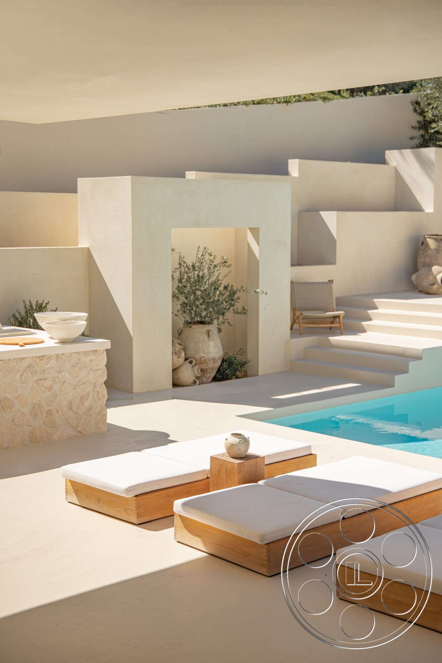 Modern 535 - natural stone accents, minimalist design, landscaped greenery, rectangular swimming pool, stucco walls, concrete pool deck, wood side table, transitional outdoor space, textured plaster finishes, wood lounge chairs, beige concrete flooring, rounded planter