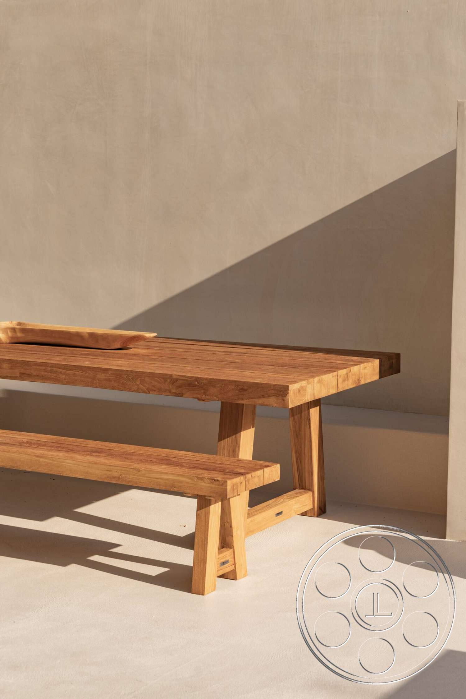Modern 535 - neutral color palette, clean lines, minimalist design, natural wood dining table, light-colored concrete flooring, smooth plaster wall, teak wood bench, angular table and bench forms