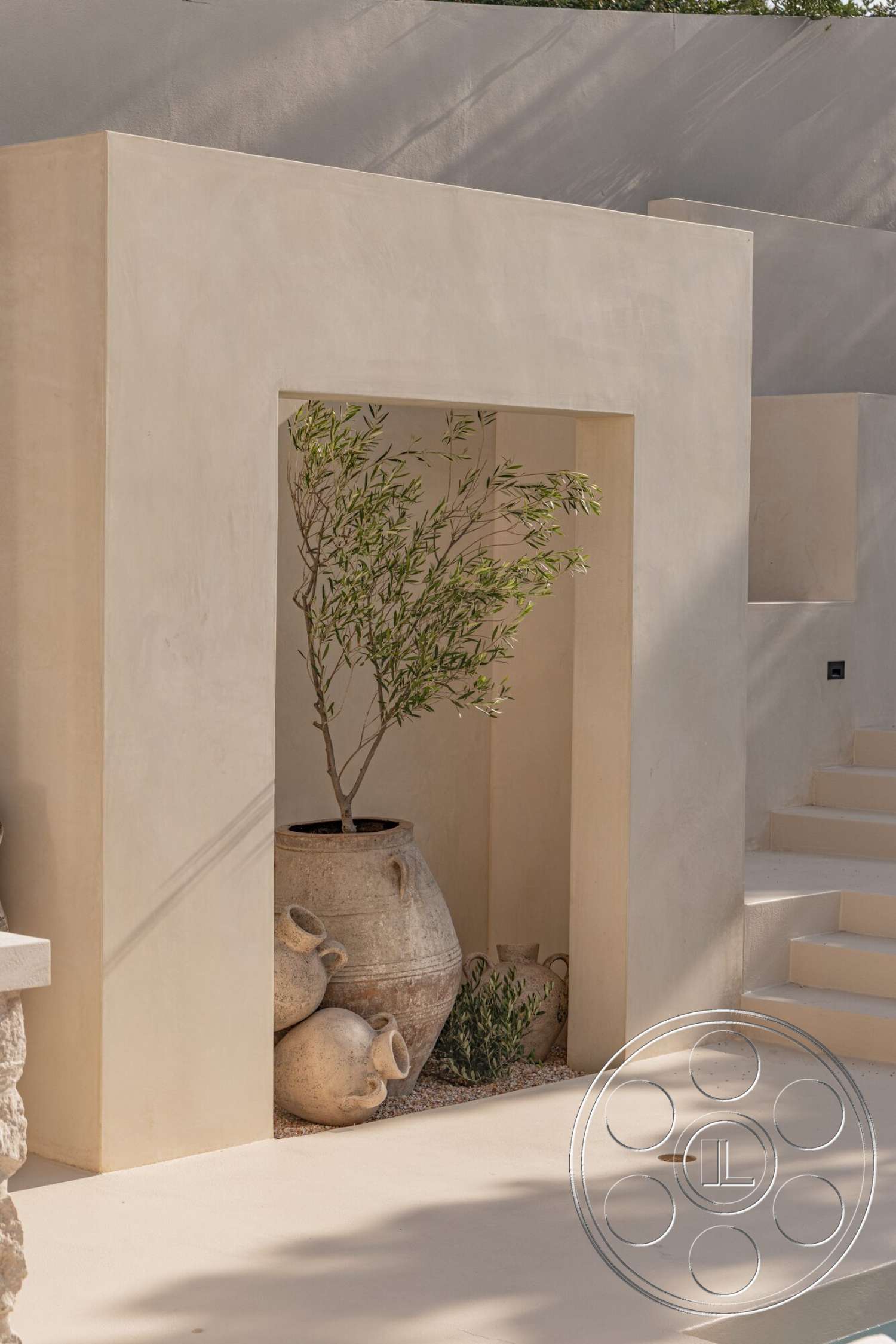Modern 535 - neutral color palette, exterior, textured plaster walls, minimalist landscaping, natural stone steps, drought-tolerant plants, stone feature wall, decorative clay pottery, rectangular plant nook, parged concrete flooring