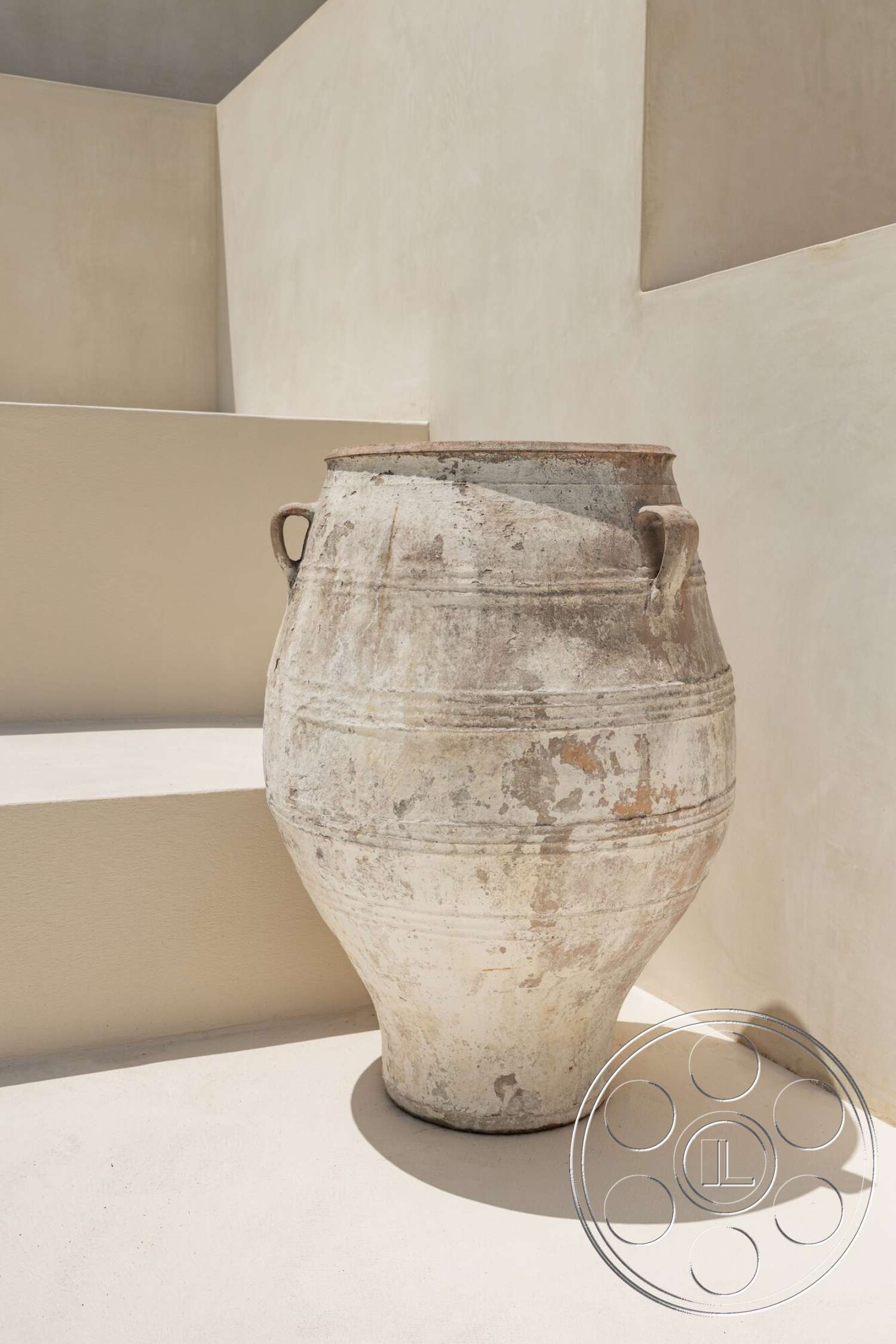 Modern 535 - exterior, neutral stucco walls, minimalist architectural design, smooth concrete steps, weathered clay pot, textured ceramic surface, rounded pot shape, light-colored outdoor setting
