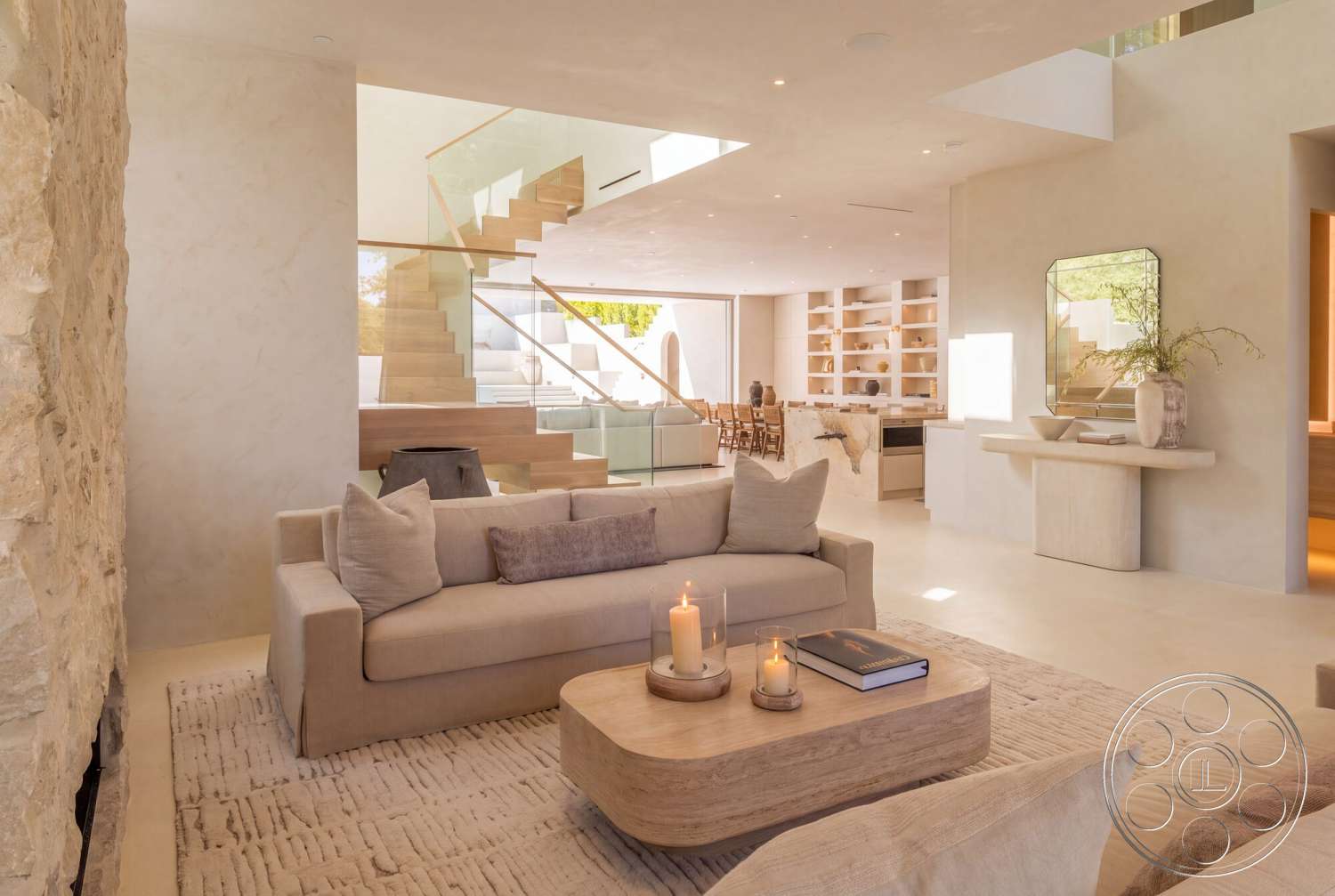 Modern 535 - neutral color palette, wood coffee table, open floor plan, decorative vases, concrete flooring, modern lighting fixtures, floor-to-ceiling windows, plush area rug, glass railing staircase, natural light-filled space, built-in shelving unit, exposed stone accent wall, plaster wall finishes, minimalist sofa, wood platform staircase, light-colored accent pillows, floating console table, integrated kitchen design