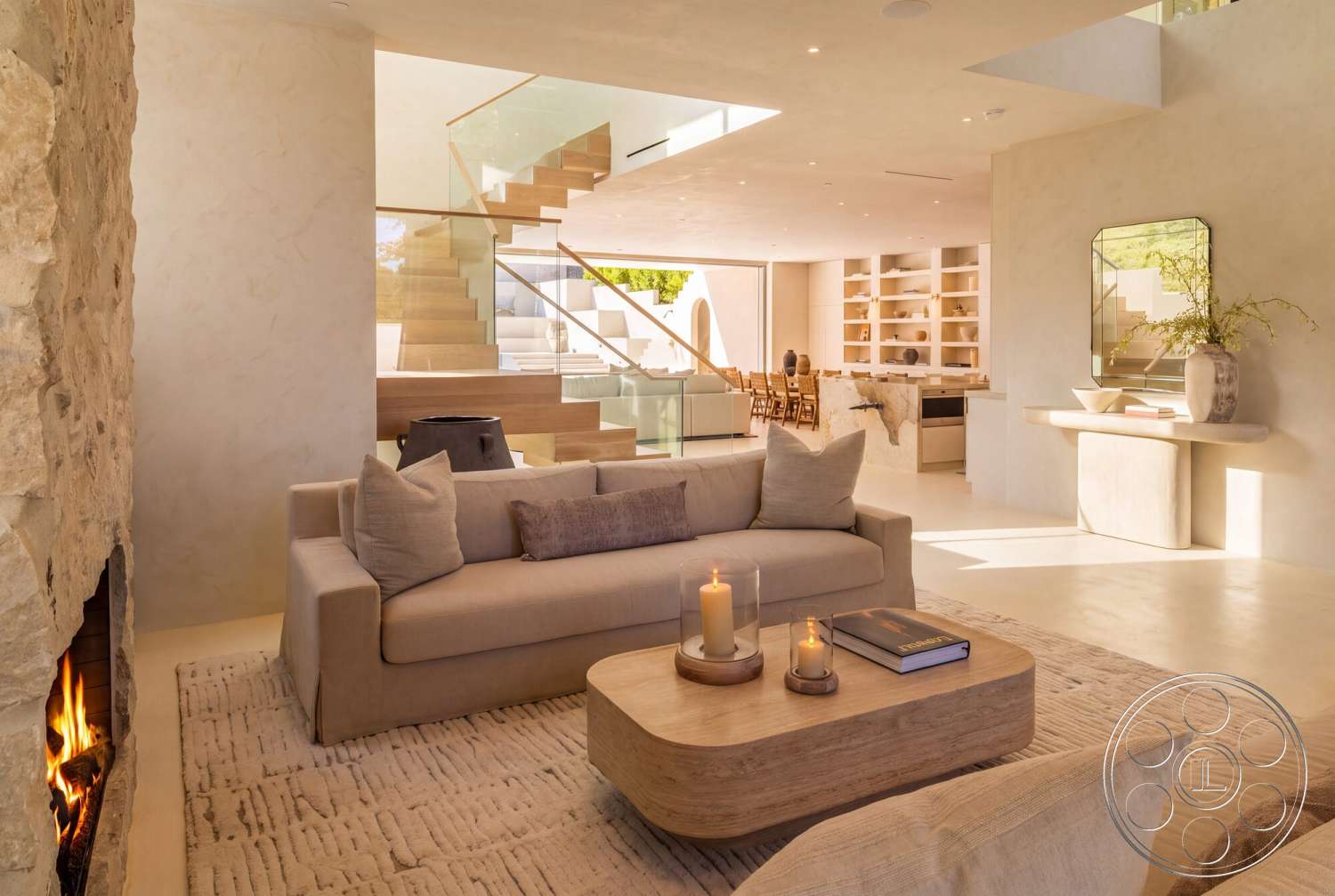 Modern 535 - neutral color palette, wood coffee table, textured area rug, floor-to-ceiling windows, smooth concrete flooring, bright and airy atmosphere, contemporary dining area, floating staircase, open-concept living area, minimalist decor elements, integrated shelving units, hardwood staircase treads, sculptural side table, plaster interior walls, soft upholstered sofa, glass stair railings, exposed stone fireplace wall, natural light-filled open space