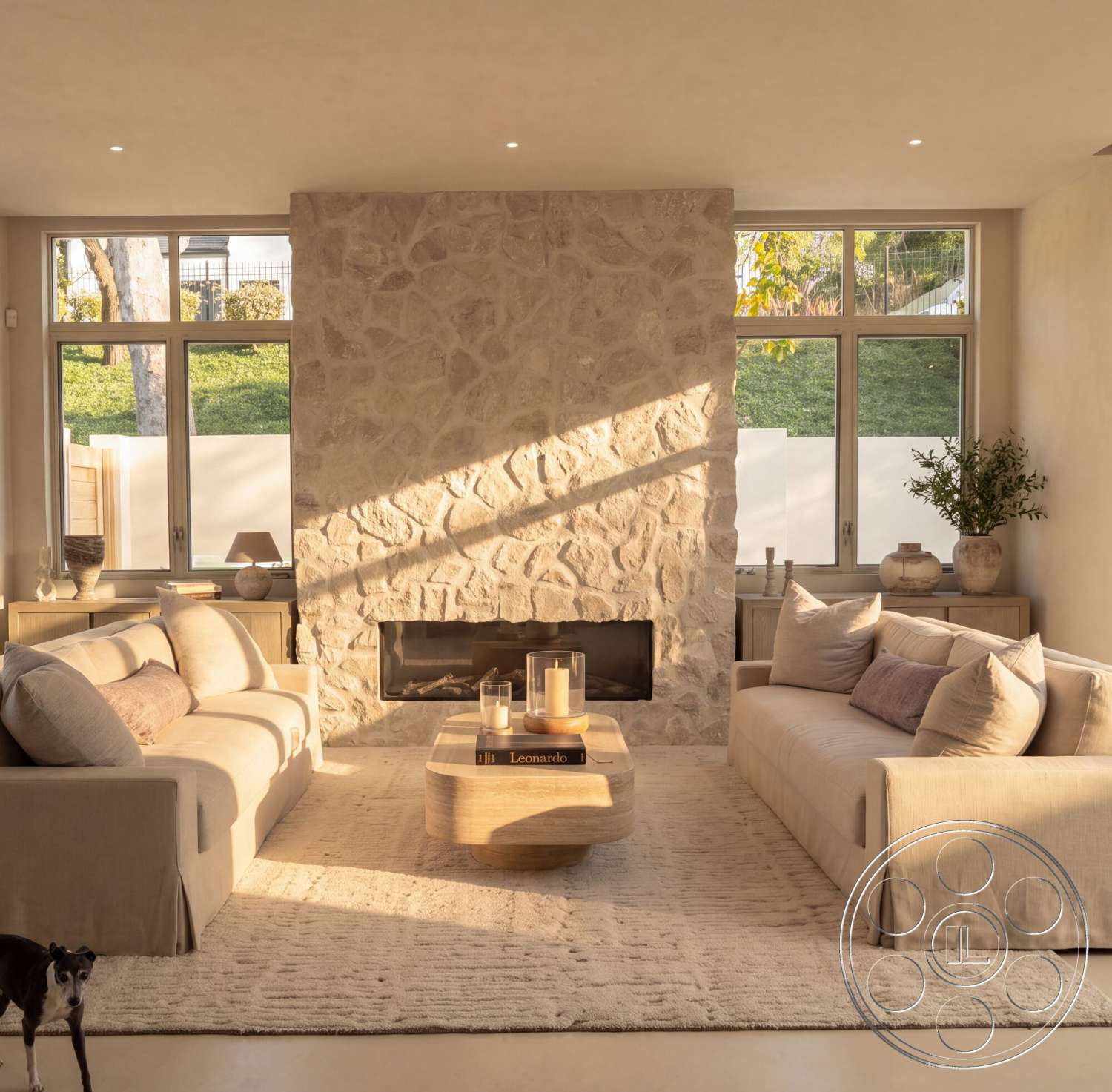 Modern 535 - natural light, exterior, floor-to-ceiling windows, soft area rug, textured plaster walls, contemporary living room, minimalist interior design, stone fireplace wall, indoor plant accents, hardwood coffee table, light-colored wall treatment, light fabric upholstery sofas, simple decorative vases