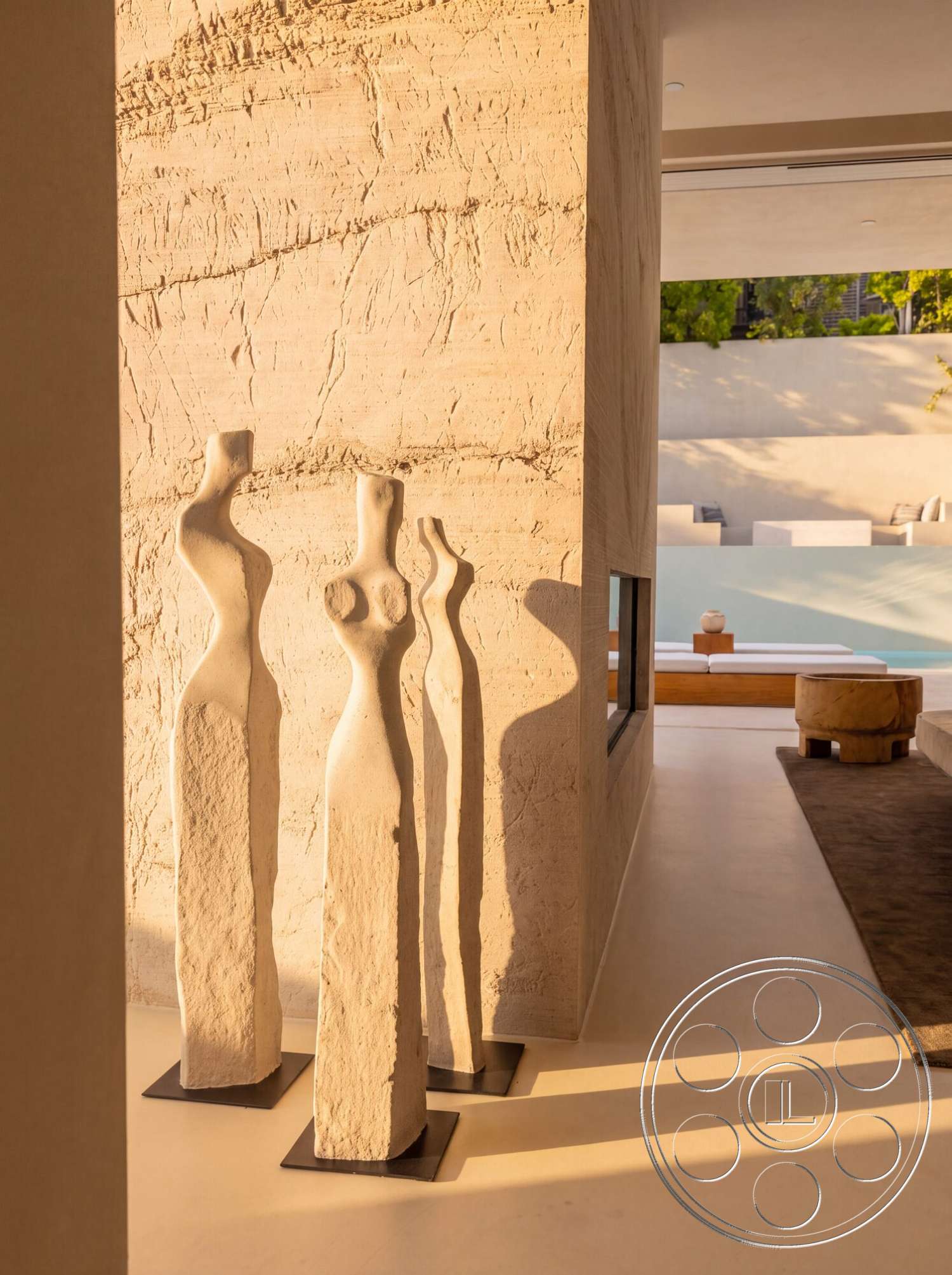 Modern 535 - neutral color palette, minimalist aesthetic, concrete flooring, open space design, seamless indoor-outdoor transition, floor-to-ceiling windows, modern architectural style, textured plaster walls, artistic wall features, sculptural accent elements, natural light play