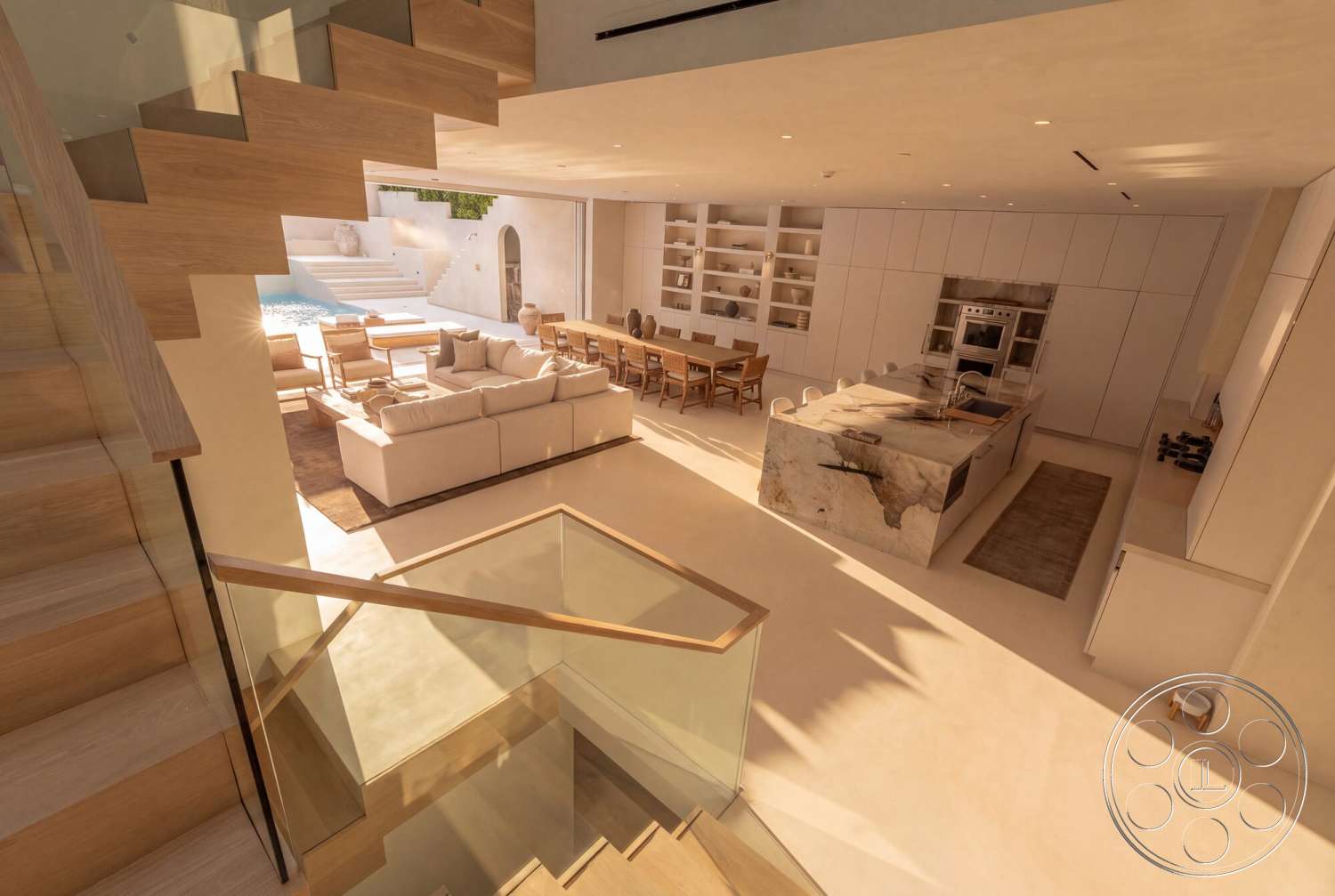 Modern 535 - minimalist design, wood dining table, glass railing, floor-to-ceiling windows, open-concept living space, textured plaster ceiling, cushioned sectional sofa, white plaster walls, modern kitchen cabinetry, marble kitchen island, exterior pool area, porcelain tile flooring, natural light-filled interior, light wood staircase, lounge area with patio access