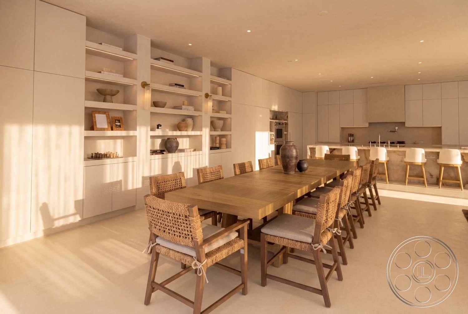 Modern 535 - neutral color palette, concrete flooring, wood dining table, track lighting, white cabinetry, stone countertop, built-in shelves, woven dining chairs, open plan layout, minimalist kitchen design