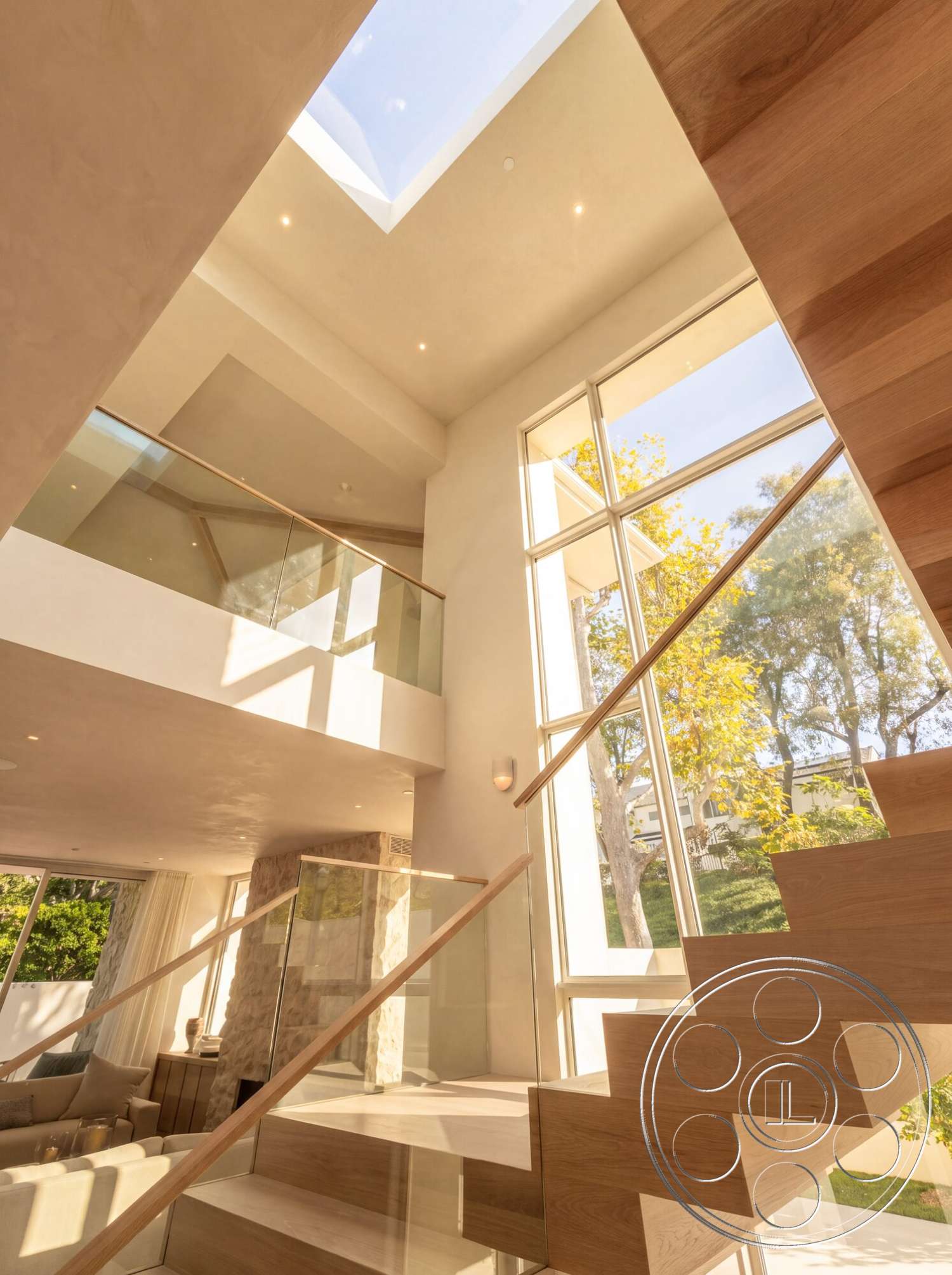 Modern 535 - exterior, glass railing, open concept design, wooden staircase, floor-to-ceiling windows, vaulted ceiling, modern architectural style, hardwood floor, textured plaster walls, natural light interior, skylight ceiling, exposed stone feature wall, minimalistic interior, lush outdoor setting