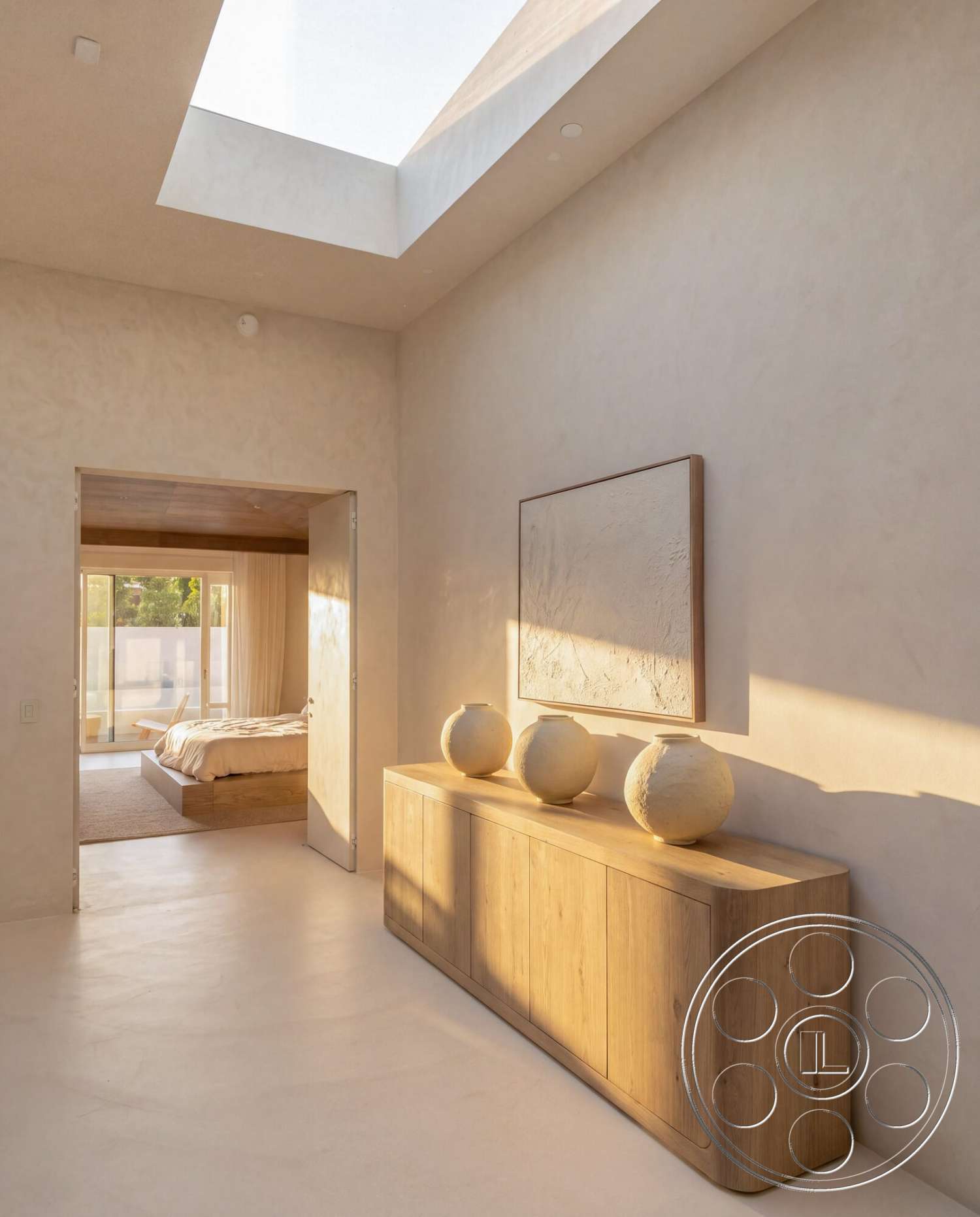 Modern 535 - neutral color palette, minimalist design elements, floor-to-ceiling windows, natural light from skylight, smooth plaster walls, soft beige carpet flooring, light-colored hardwood console table, textured artwork on wall, open doorway to bedroom, rounded ceramic vases on console