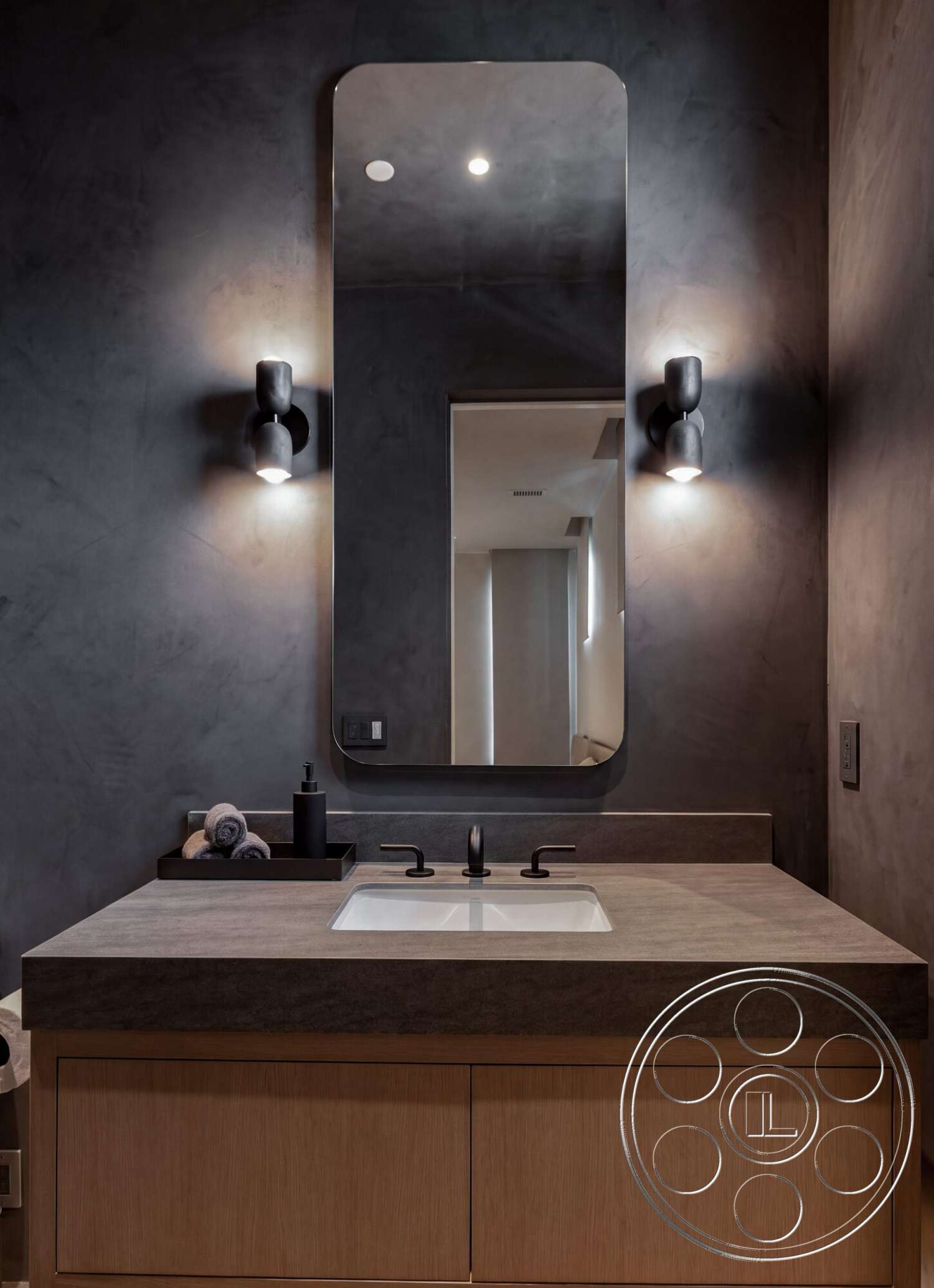 Modern 535 - neutral color palette, ambient lighting, exposed concrete wall, rectangular mirror, concrete countertop, contemporary bathroom, textured plaster wall, chrome faucet fixtures, modern bathroom design, minimalist interior, black wall sconces, wood bathroom vanity