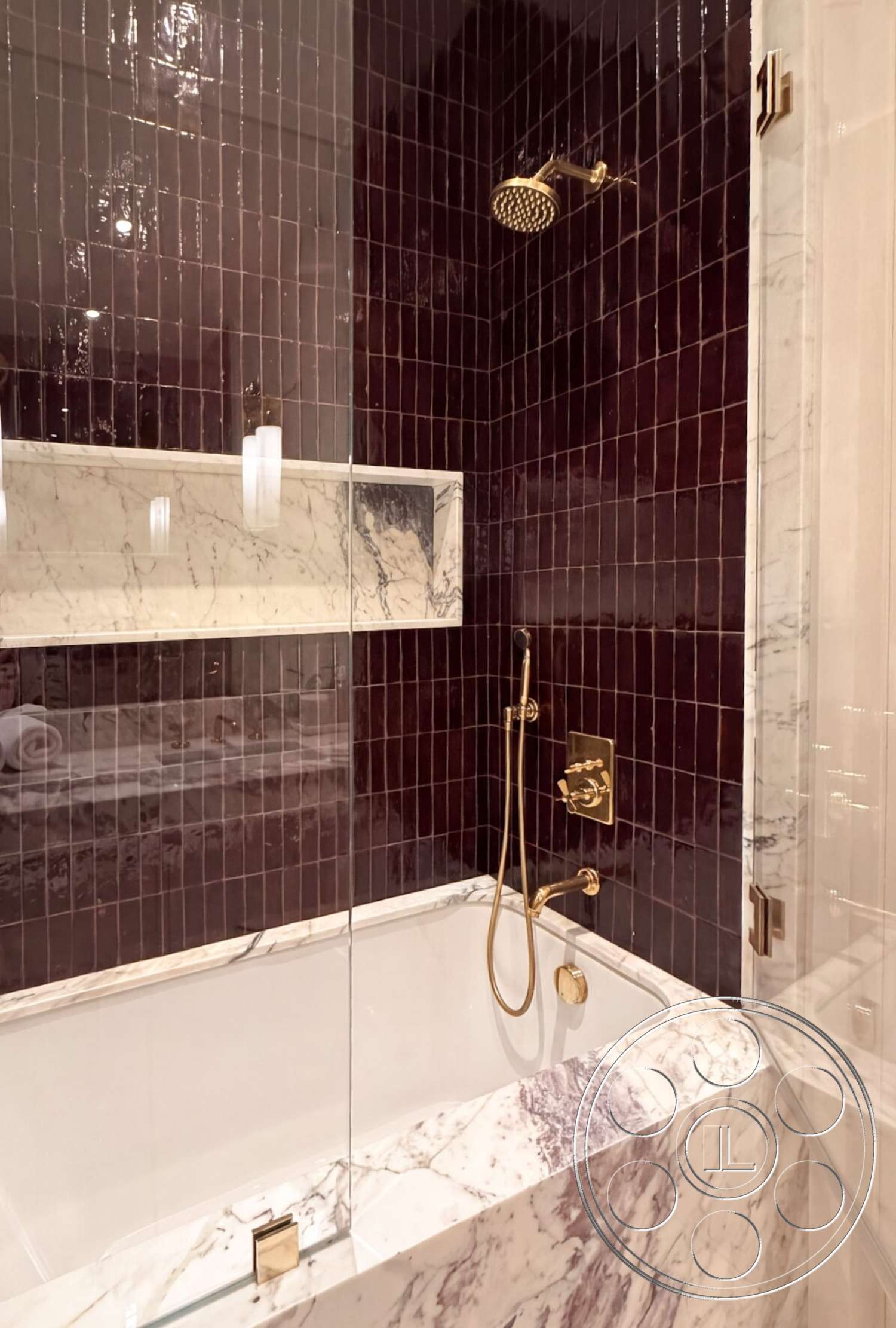 Modern 535 - recessed lighting, minimalist aesthetic, glass shower enclosure, modern bathroom design, tile bathroom walls, dark purple ceramic wall tiles, white marble bathtub surround, gold bathroom faucet, gold handheld shower, marble accent details