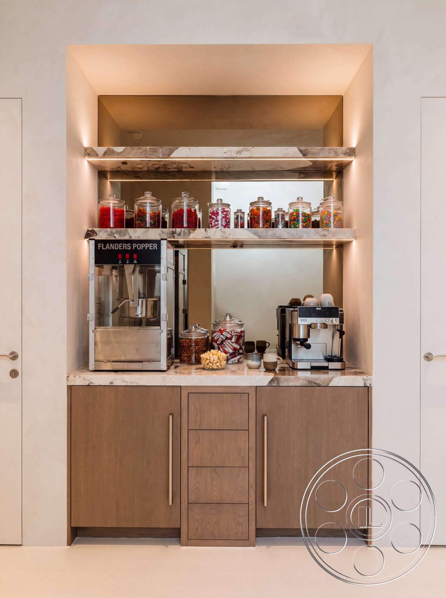 Modern 535 - wood cabinetry, marble countertop, under-cabinet lighting, coffee machine, simple door hardware, glass jars with colorful candies, stainless steel popcorn machine, neutral textured walls
