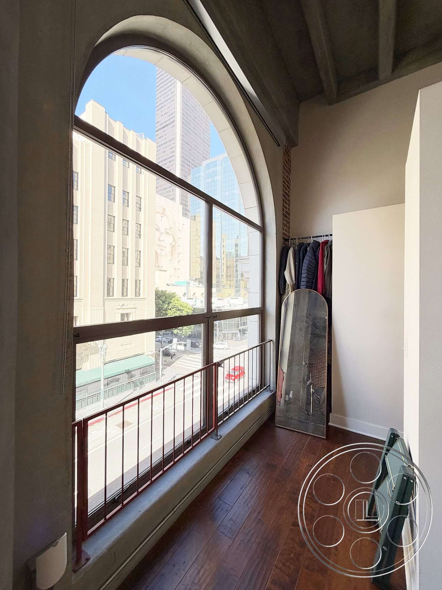 Brockman 310 - hardwood flooring, modern design, interior space, metal railing, exposed brick wall, urban skyline view, arched window, concrete ceiling